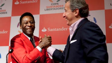 In this Wednesday, June 22, 2011 file photo, Juan Pedro Damiani, president of Uruguay's Penarol soccer club, right, shakes hands with Brazilian soccer legend Pele after a news conference in Sao Paulo, Brazil. A FIFA judge who helped ban Sepp Blatter for financial misconduct is now under investigation by his ethics committee colleagues after being named in an international probe of offshore accounts. The FIFA ethics prosecution chamber said Monday, April 4, 2016 that it “opened a preliminary investigation to review the allegations” linked to lawyer Juan Pedro Damiani of Uruguay. Damiani was identified in reports Sunday by international media who got a vast trove of data and documents leaked from a Panama law firm about evading tax and hiding assets through offshore accounts. (AP Photo/Victor R. Caivano, file)