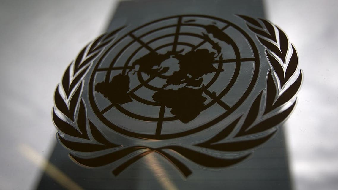 The United Nations headquarters building is pictured though a window with the UN logo in the foreground in the Manhattan borough of New York August 15, 2014. (Reuters)