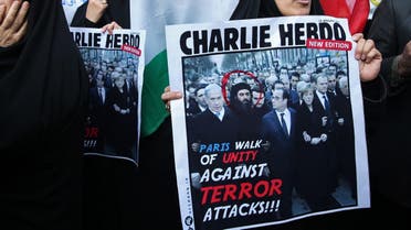 An Iranian demonstrator holds a satirical poster cover mocking the French weekly Charlie Hebdo which shows the Paris rally but adds a portrait of the ISIS leader Abu Bakr al-Baghdadi among the world leaders. (File photo: AP)