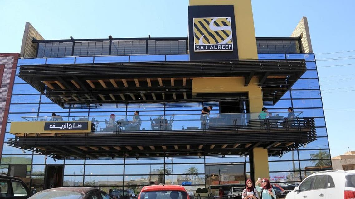 In this Sunday, April 3, 2016 photo, Iraqis have lunch at a restaurant in Baghdad, Iraq. Iraqi businessman Zaid Nazo and his business partner, Marwan Rassam, established their first eatery -- Saj al-Reef or “Country Bread” in Arabic -- in the upscale Baghdad neighborhood of Karrada 18 years ago (AP)