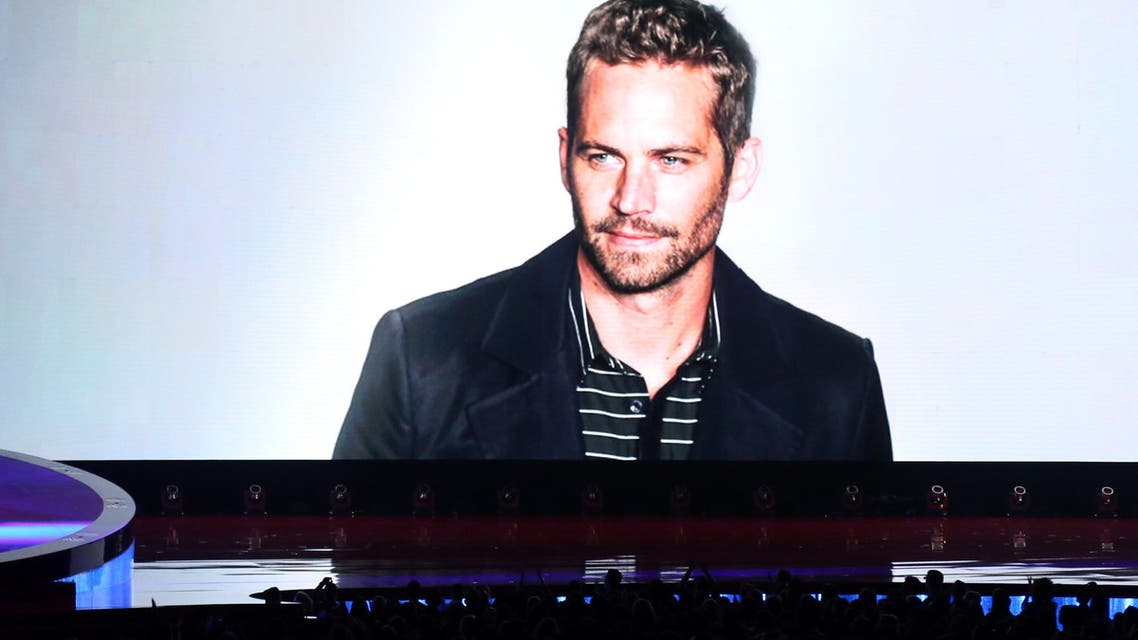 A tribute to Paul Walker is seen on screen at the MTV Movie Awards on Sunday, April 13, 2014. (AP)