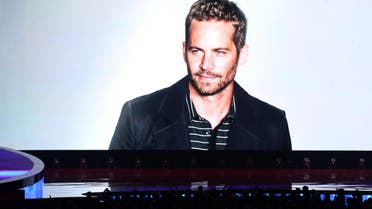 A tribute to Paul Walker is seen on screen at the MTV Movie Awards on Sunday, April 13, 2014. (AP)