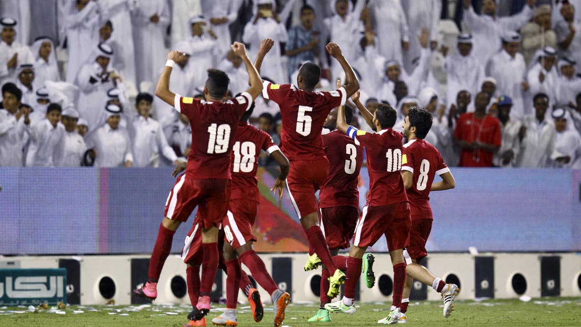 File photo: Qatar's soccer team players celebrate with fans after winning their 2018 World Cup qualifying soccer match against China in Doha, Qatar, October 8, 2015. (Reuters)