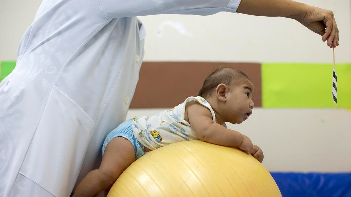 Beijamin Santos who was born with microcephaly undergoes physical therapy at a therapy treatment center in Joao Pessoa, Brazil, Thursday, Feb. 25, 2016. Researchers from the Centers of Disease Control and Prevention continue to fan out across one of Brazil's poorest states in search of mothers and infants for a study aimed at determining whether the Zika virus is causing babies to be born with unusually small heads. (AP)