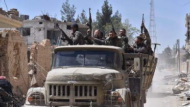 Syrian soldiers celebrate their victory against the Islamic State group in Qaryatain, Syria, Monday, April 4, 2016. AP