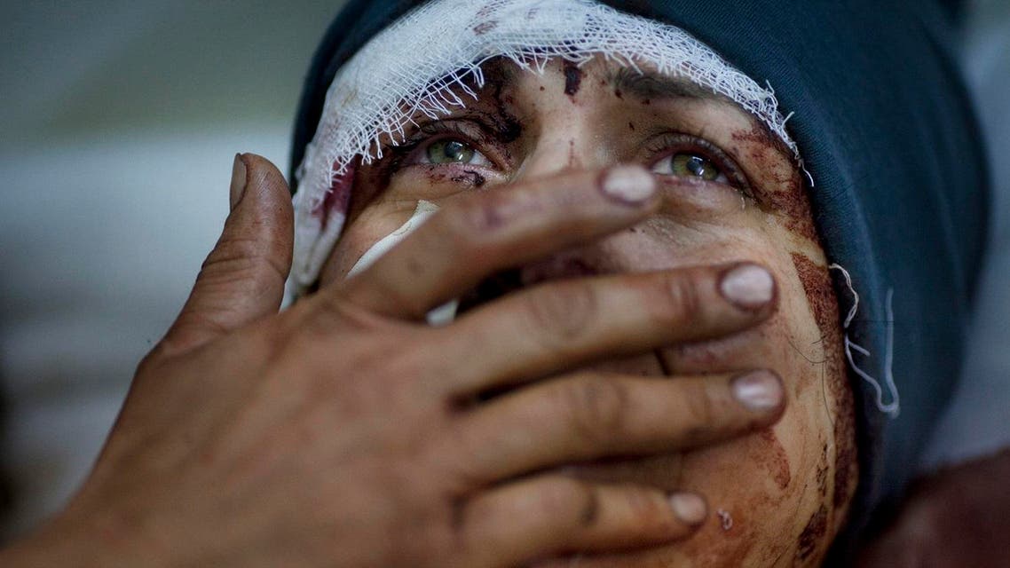 A woman named Aida cries as she recovers from severe injuries after the Syrian army shelled her house in Idlib, northern Syria, March 10, 2012. (AP)