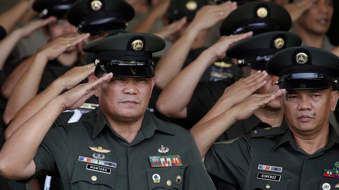 Philippine Army officers salute during ceremonies at the 119th founding anniversary of the Philippine Army in suburban Taguig, south of Manila, Philippines on Tuesday, March 22, 2016. Under the administration of Philippine President Benigno Aquino III, the Philippine military continues to it's modernization program as it deals with major security concerns, including Communist and Muslim insurgencies and South China Sea territorial disputes involving China, the Philippines and four other governments. (AP Photo/Aaron Favila)