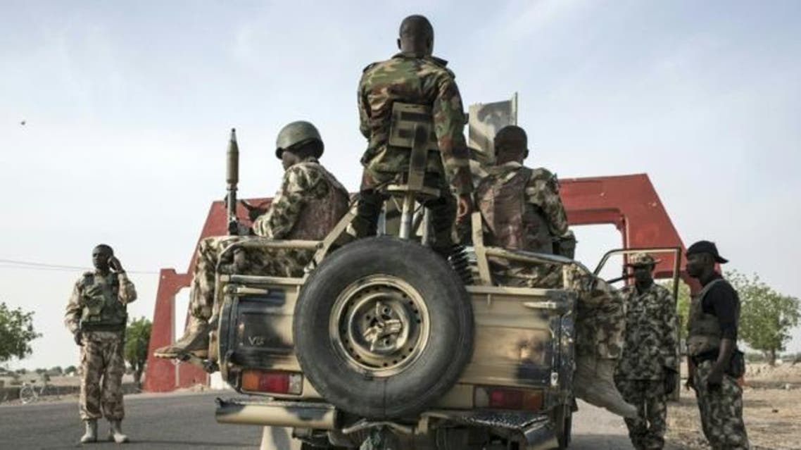 Soldiers of the Nigerian Army prepare to leave Maiduguri in a heavily armed convoy on the road to Damboa in Borno State northeast Nigeria on March 25, 2016 (AFP)