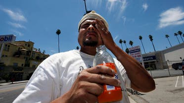 Wilfredo Aguilar wipes sweat from his forehead as he takes a break from painting a building under the hot sun on Hollywood Boulevard in Los Angeles, Thursday, June 19, 2008. Southern California roasted Thursday in a record-breaking, end-of-spring heat wave that sent temperatures soaring past 100 degrees in many areas, posing hazards for anyone who ventured outside. (AP)