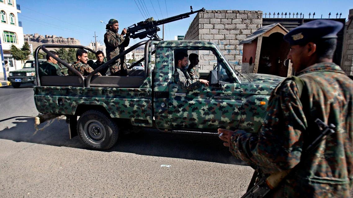 Yemeni soldiers stand guard at a street leading to a state security court during a trial of suspected al-Qaida militants in Sanaa, Yemen, Sunday, Jan. 6, 2013. Yemen's state security court has sentenced five alleged al-Qaida militants to up to 10 years in prison for carrying out attacks against security forces and supporting the group logistically in the southern province of Abyan in 2011. (AP Photo/Hani Mohammed)