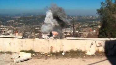In this frame grab made from the Russian Defense Ministry Press Service, an artillery shell explodes about 150 meters away from a group of journalists in the Syrian village of Kinsibba, about 5 kilometers from Turkey border onTuesday, March 1, 2016. A series of artillery shells exploded on the main street of Kinsibba, sending a group of international reporters running for cover and underscoring the limits of Syria's partial cease-fire. (AP Photo/Russian Defense Ministry Press Service pool photo via AP)