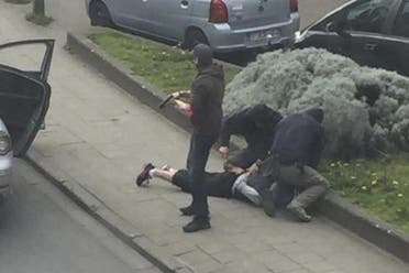 Police officers detain a suspect during a raid in which fugitive Mohamed Abrini was arrested in Anderlecht, near Brussels, Belgium, April 8, 2016 in this still image taken from video. REUTERS/Sebastien Dana-Kamran via Reuters