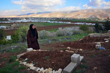 In this Tuesday, March 29, 2016 photo, Syrian refugee Saada Khalaf, 45, who fled from the city of Homs, Syria, cries near the grave of her husband Ali Jomaa, in the eastern village of Dalhamyeh, in the Bekaa valley, Lebanon. 