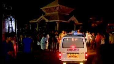 An ambulance is seen next to people after a fire broke out as people gathered for a fireworks display at a temple in Kollam, southern India, in this still image taken from video April 10, 2016. REUTERS/ANI via REUTERS
