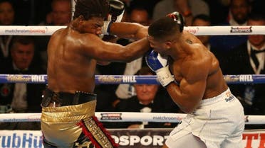   British boxer Anthony Joshua (R) delivers a knock out punch to US boxer Charles Martin during their IBF World Heavyweight title boxing match at the O2 arena in London (AFP)