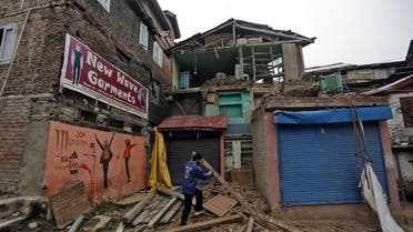 A man clears debris after his house partially collapsed following an earthquake, in Srinagar, India April 10, 2016 (Reuters)
