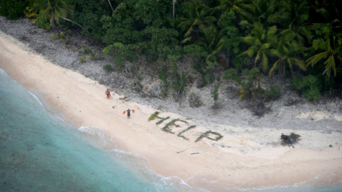  The men waved life jackets next to palm fronds spelling the word ‘help’ on the island of Fanadik, where they were stranded for three days. (US Navy/Reuters)