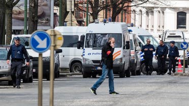 Police secure an area during a house search in the Etterbeek neighborhood in Brussels on Saturday April 9, 2016. 