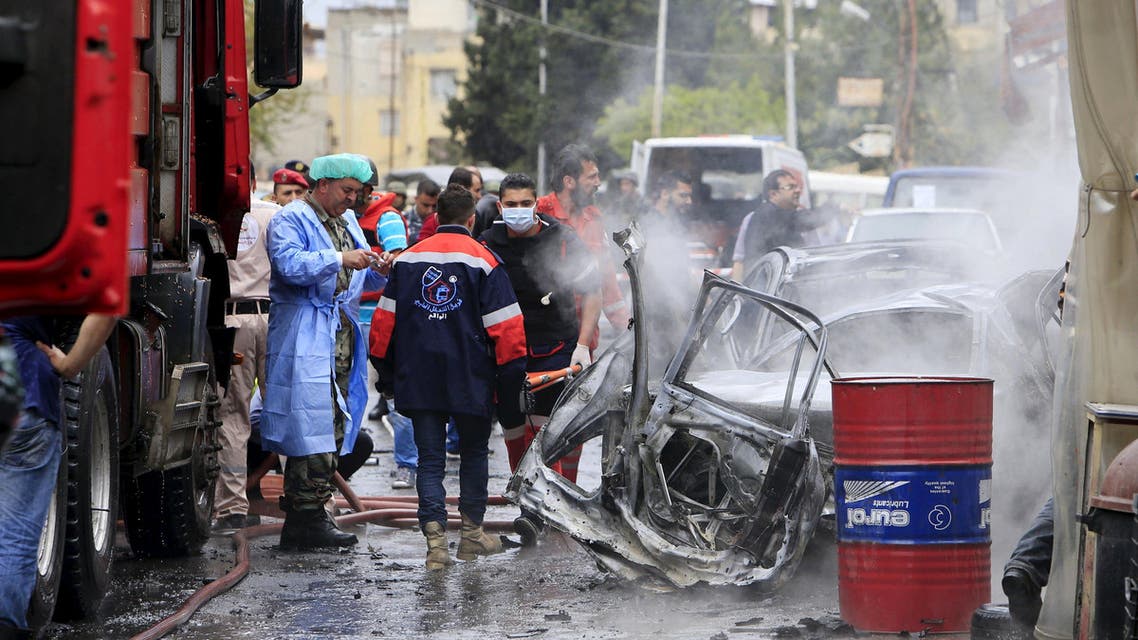 Security and civil defense members inspect a car wreck after an explosion that killed Fathi Zaydan, a Fatah official responsible for the Palestinian camp of Mieh Mieh in Sidon, near Ain al-Hilweh Palestinian refugee camp, near the port-city of Sidon, southern Lebanon, April 12, 2016. REUTERS/Ali Hashisho TPX IMAGES OF THE DAY