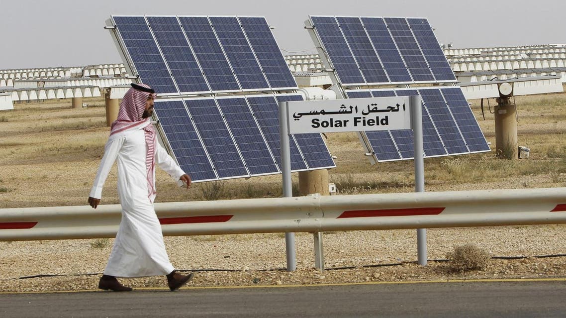 A Saudi man walks on a street past a field of solar panels at the King Abdulaziz city of Sciences and Technology, Al-Oyeynah Research Station. (File photo: Reuters)