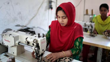 In this Monday, April 20, 2015 photo, Bangladeshi garment workers, who worked at the Rana Plaza garment factory that collapsed two years ago, work at a factory meant to rehabilitate survivors of the accident, the worst in the history of the garment industry, in Savar, near Dhaka, Bangladesh. 