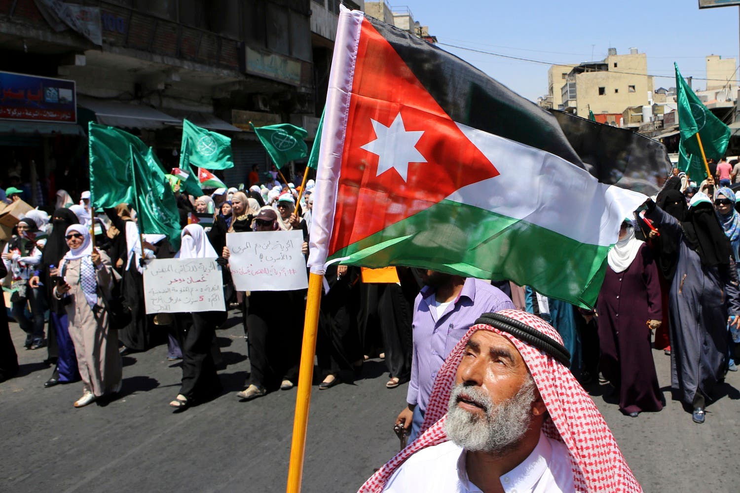 In this July 31, 2015 file photo, a Jordanian protester carries the national flag during a rally by the Muslim Brotherhood, in Amman, Jordan. The Jordan branch recently severed ties with the region-wide movement based in Egypt (File Photo: AP)