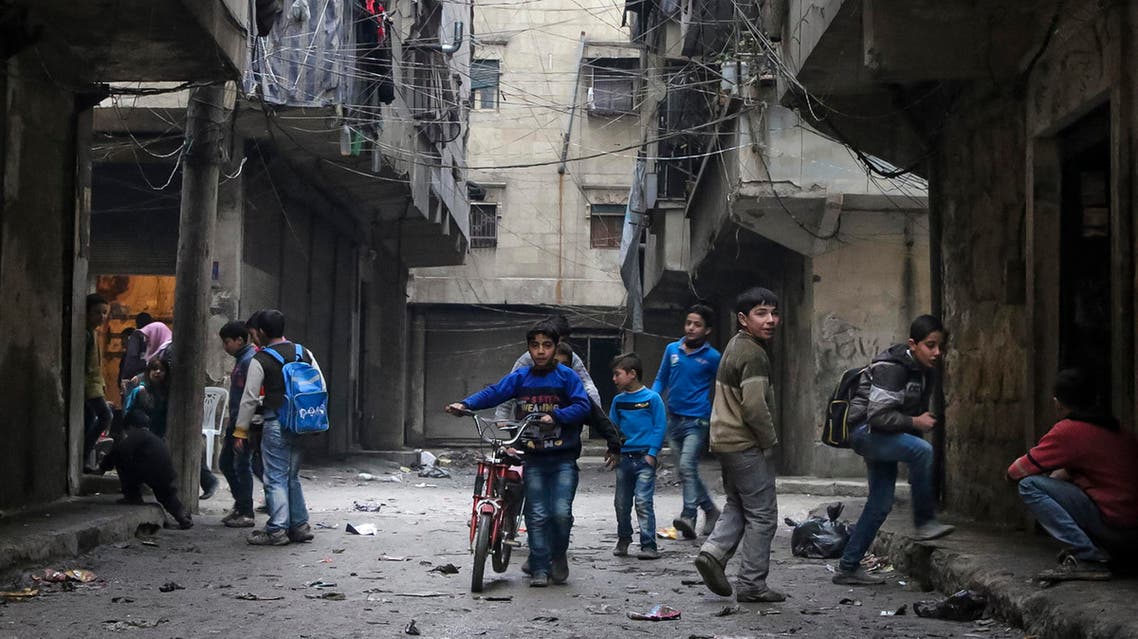 n this Thursday, Feb. 11, 2016 photo, school boys play in a street in Aleppo, Syria.