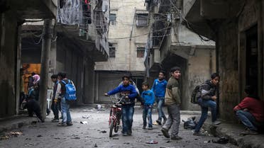 n this Thursday, Feb. 11, 2016 photo, school boys play in a street in Aleppo, Syria. 