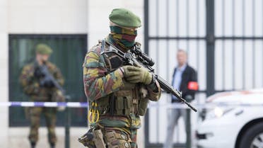 A Belgian special forces police officer and soldiers secure the zone outside a courthouse while Brussels attacks suspects Mohamed Abrini and Osama Krayem appear before a judge, in Brussels, Belgium, April 14, 2016. REUTERS/Yves Herman
