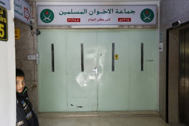 A boy who stands near the main entrance of the Muslim Brotherhood's office in Amman, after it was shut by police acting on orders of the Amman governor April 13, 2016. (Reuters)