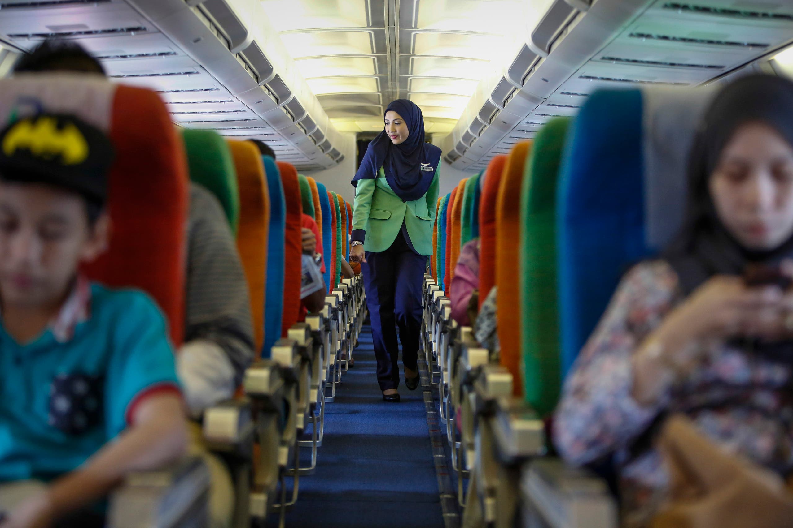 Happier days In this Dec. 22, 2015, photo, a Rayani Air flight crew walks down the aisle on board before departure at Kuala Lumpur International Airport 2 in Sepang, Malaysia. (AP)