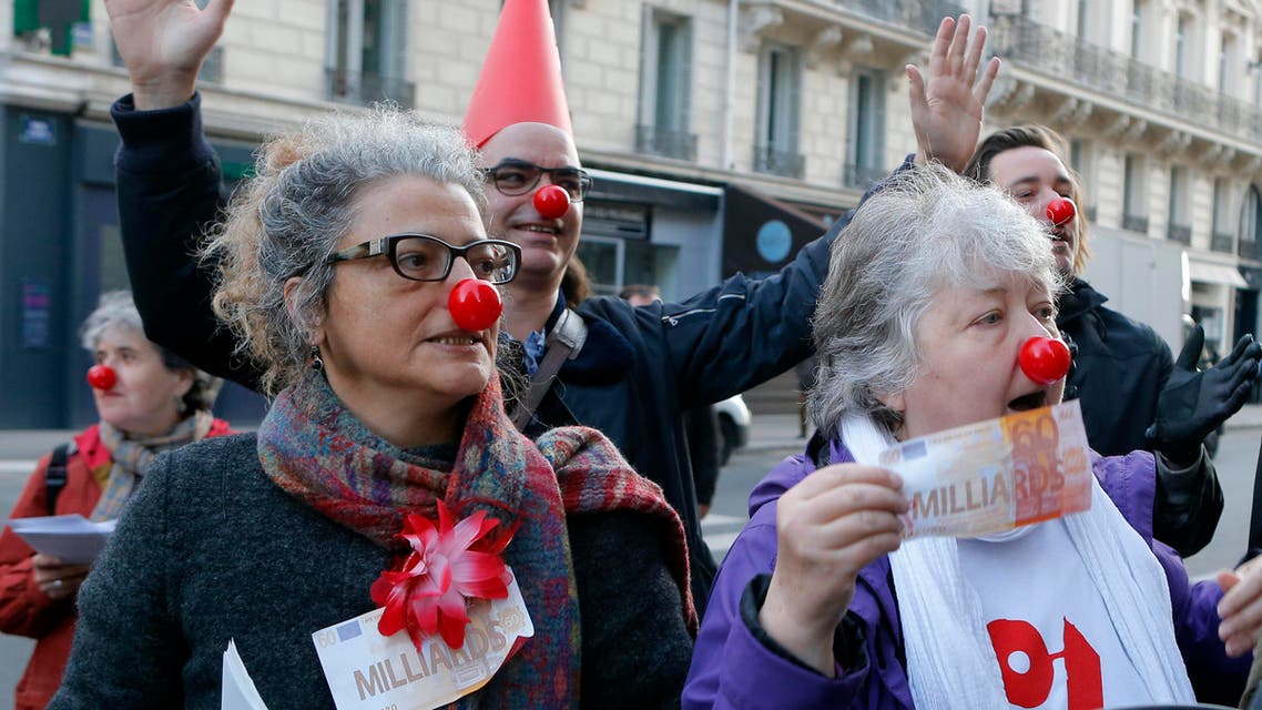 Activists display fake banking notes during a banking managers meeting, in Paris, France, Thursday, April 14, 2016, following the Panama disclosures. (AP)