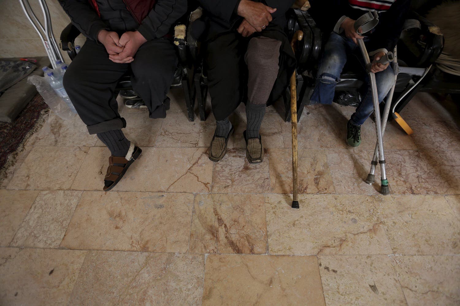 Men with amputated limbs wait to be inspected in the rebel-controlled area of Maaret al-Numan town in Idlib province, Syria March 20, 2016. REuter