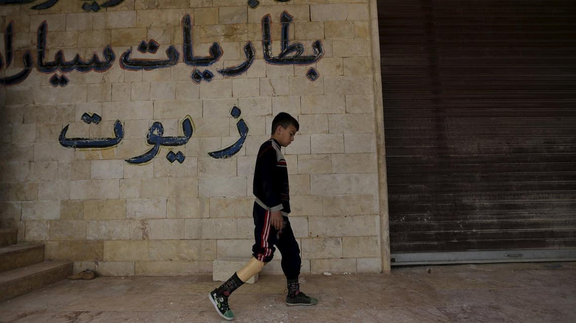 A boy with an amputated leg walks using an artificial limb in the rebel-controlled area of Maaret al-Numan town in Idlib province, Syria March 20, 2016. Reuters