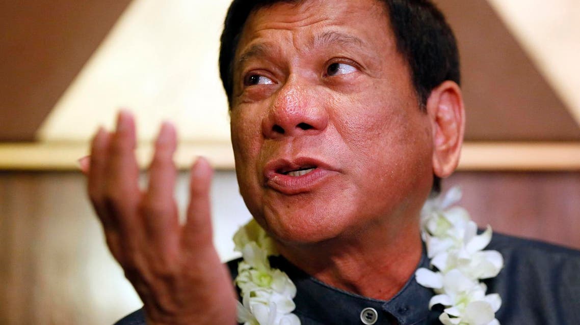 In this March 10, 2016 photo, Davao City Mayor Rodrigo Duterte talks to the media prior to addressing seafarers organization in Manila, Philippines. Nicknamed “Duterte Harry,” after a Clint Eastwood character with little regard for rules, the Philippine city mayor casually threatens to shoot criminals, hang them like dirty laundry or drown them in Manila Bay. His expletives have sideswiped even the deeply revered pope. Despite such brazen talk, Rodrigo Duterte has emerged as a top contender in Philippine presidential elections on May 9 in an impressive political rise that has been likened to Donald Trump's. The tough-talking mayor finds the comparison offensive and draws the line. (AP Photo/Bullit Marquez)