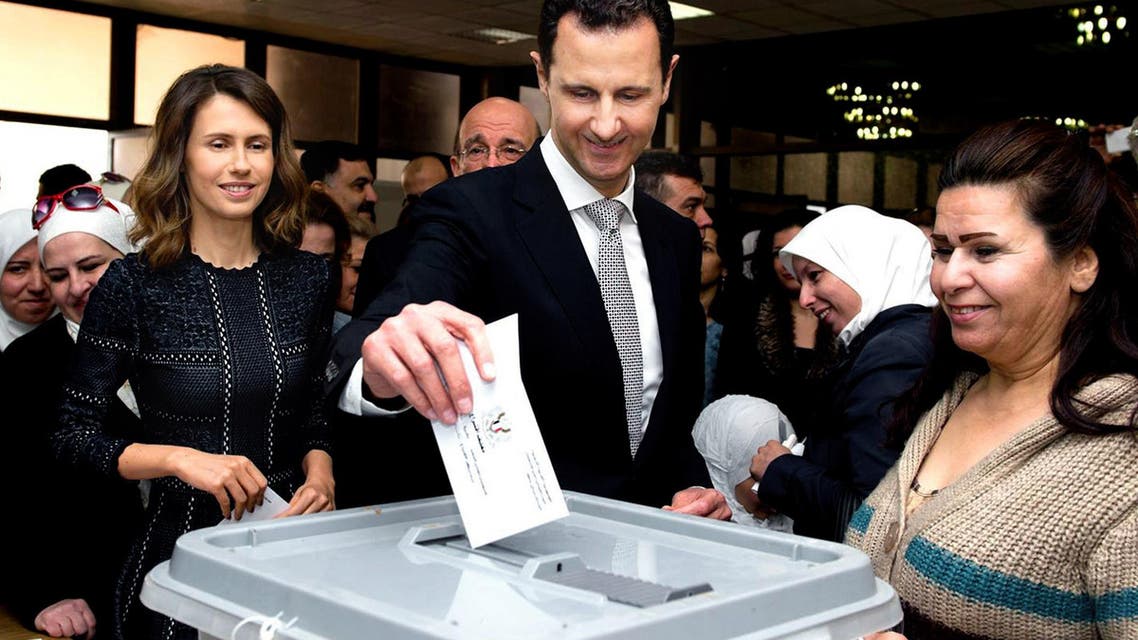 This photo released on the official Facebook page of Syrian Presidency, shows Syrian President Bashar Assad casting his ballot in the parliamentary elections, as his wife Asma, left, stands next to him, in Damascus, Syria, Wednesday, April 13, 2016. AP