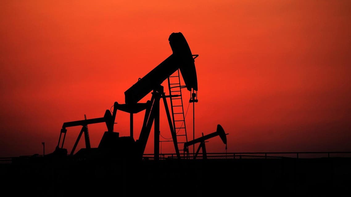 Oil pumps work at sunset on Wednesday, Sept. 11, 2013, in the desert oil fields of Sakhir, Bahrain. Across a Mideast fueled by oil production, low global prices have some countries running on empty and scrambling to cover shortfalls, even as more regional crude is on tap to enter the market.(AP)