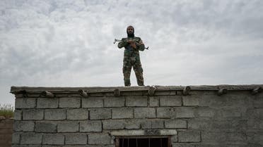 In this April 9, 2016 photo, a fighter with the Shamar tribal militia stands guard on the border with Syria, in Rabia, northwestern Iraq. (AP)