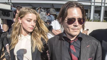 Actor Johnny Depp (R) and wife Amber Heard arrive at the Southport Magistrates Court on Australia's Gold Coast, April 18, 2016. Hollywood actor Johnny Depp's wife, actress Amber Heard, appeared in the Queensland court Monday charged with illegally smuggling the couple's Yorkshire terriers, Pistol and Boo, into the country on a private jet while Depp was shooting a Pirates of the Caribbean movie last year. (Reuters/Dave Hunt/AAP