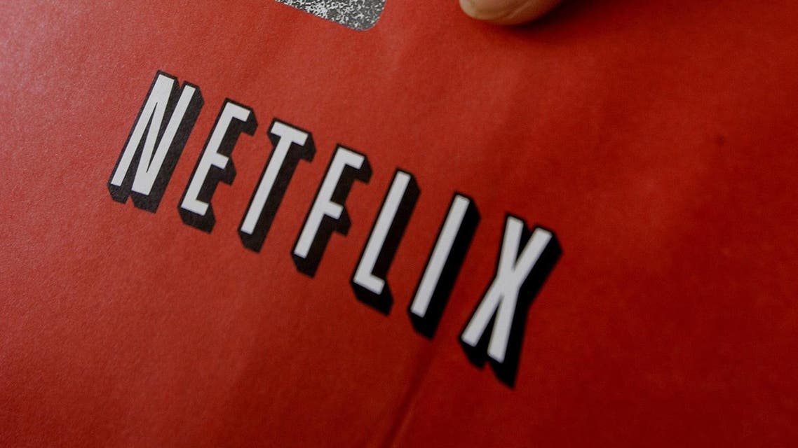 In this July 21, 2006 file photo, Netflix customer Victoria Tichenor poses with a Netflix envelope and a DVD in Palo Alto, Calif. Netflix on Tuesday, July 12, 2011 said it is raising its prices by as much as 60 percent for millions of subscribers who want to rent DVDs by mail and watch video on the Internet. (AP)