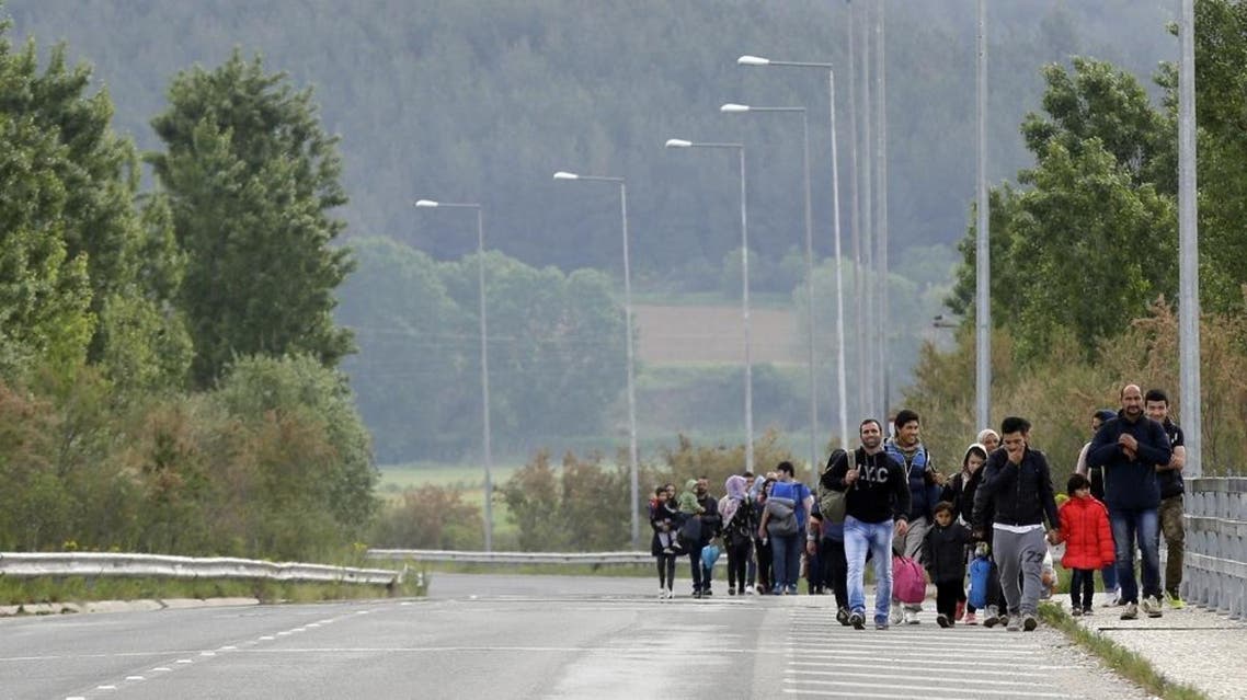 Afghan migrants walk towards the northern Greek border point of Idomeni, Greece, Tuesday, April 19, 2016 (AP)