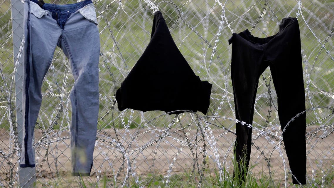 Migrants wait to cross into Macedonia