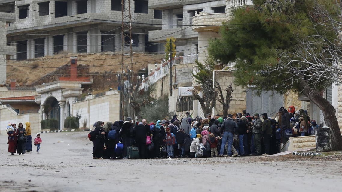 Syrians wait for an aid convoy in the besieged town of Madaya in the countryside of Damascus, Syria on Thursday, Jan. 14, 2016 as part of a UN-sponsored aid operation in this war-torn country. (AP Photo)