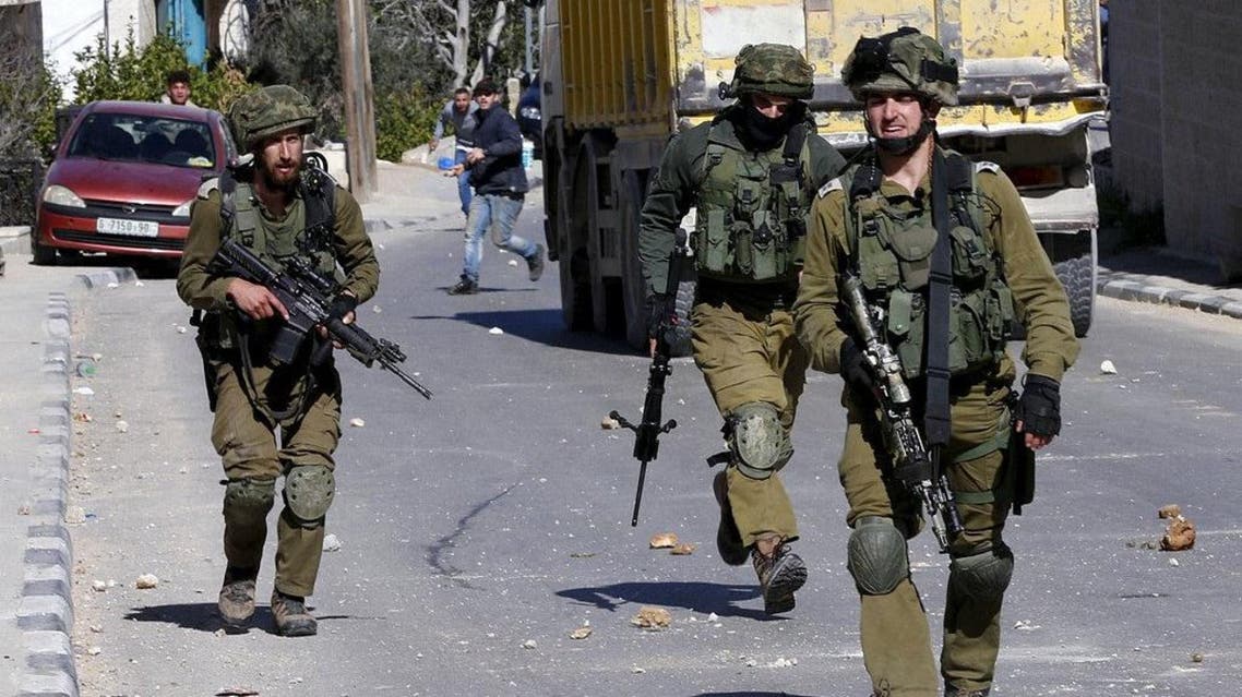 Palestinians throw stones towards Israeli soldiers during clashes in al-Amari refugee camp near the West Bank city of Ramallah, February 15, 2016. (Reuters)