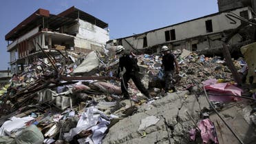 Rescue team members search for victims at a collapsed store and buildings at the village of Manta, after an earthquake struck off Ecuador’s Pacific coast, April 21, 2016. (Reuters)
