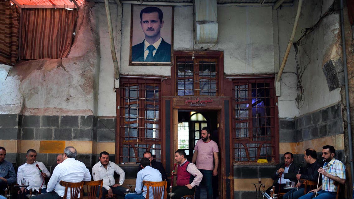 In this Saturday, April 16, 2016 photo, Syrians smoke water pipes at a coffee shop at the Hamidiyeh market, in the Old city of Damascus, Syria. AP