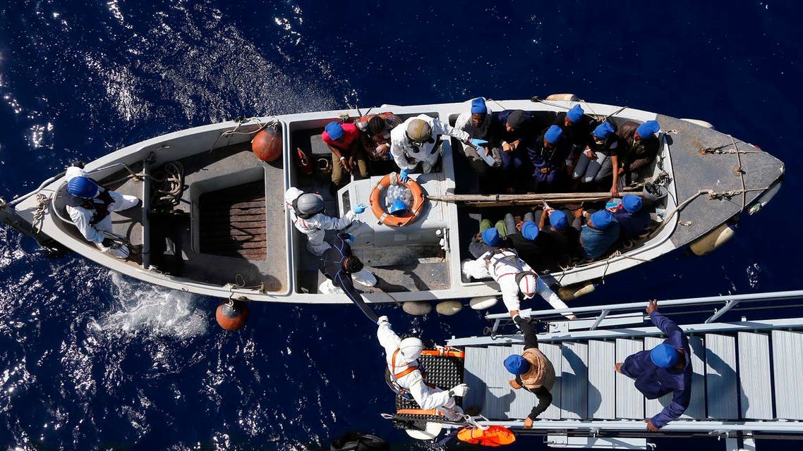 In this March 29, 2016 picture migrants get help by Italian sailors to transfer from the German combat supply ship 'Frankfurt am Main' to the their ship 'Grecale' after being rescued during EUNAVFOR MED Operation Sophia in the Mediterranean Sea off the coast of Libya. (AP)