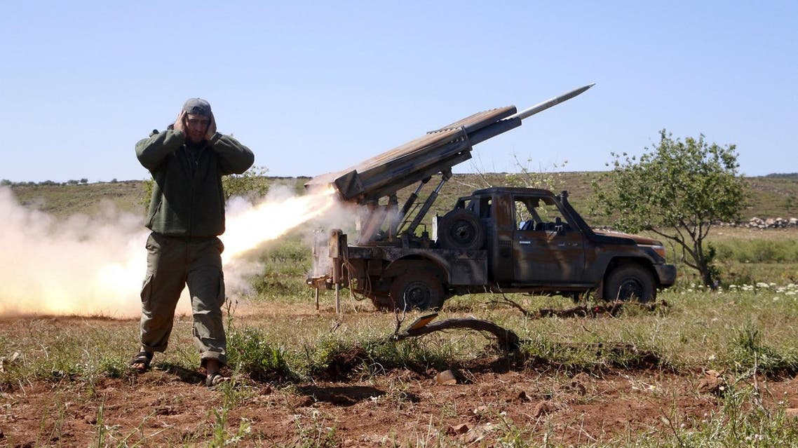 A rebel fighter from the Ahrar al-Sham Islamic Movement reacts as they fire grad rockets from Idlib countryside, towards forces loyal to Syria's President Bashar al-Assad stationed at Jureen town in al-Ghab plain in the Hama countryside, April 25, 2015. The Ahrar al-Sham Islamic Movement is participating in an operation providing backup support for fellow rebel fighters in Jisr al-Shughour after they took control of the area. Islamist insurgents including al-Qaeda's wing in Syria Nusra Front on Saturday captured large parts of the northwestern Syrian town of Jisr al-Shughour for the first time in the four year conflict. Syrian activists and a violence monitoring group said that fighters have pushed inside the town which lies on a road between the coastal city of Latakia and Syria's second city of Aleppo, after days of heavy fighting. REUTERS