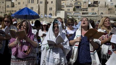 Jewish women wear prayer shawls as they pray during the Jewish holiday of Passover in front of the Western Wall, the holiest site where Jews can pray, in Jerusalem's Old City, Sunday, April 24, 2016 (AP)