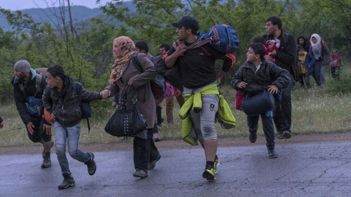 Syrian refugees cross a road while on the run in a forest in Macedonia after illegally crossing Greek-Macedonian border near the city of Gevgelija on April 23, 2016. (Reuters)